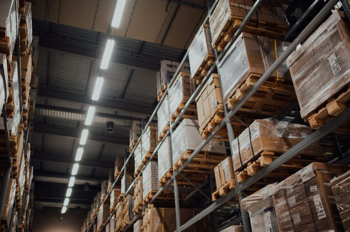 Warehouse racking stacked high with palletised goods ready to move